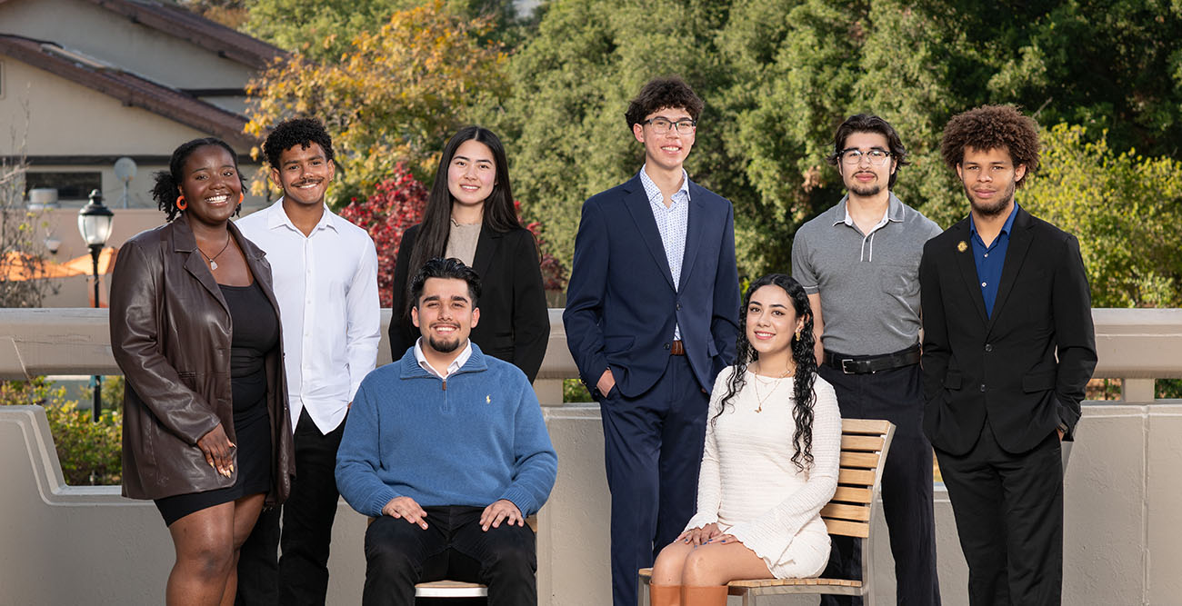 an eight-person group photo of the 2025-26 Obama Scholars cohort