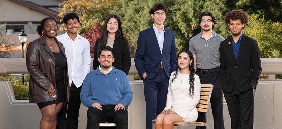 an eight-person group photo of the 2025-26 Obama Scholars cohort