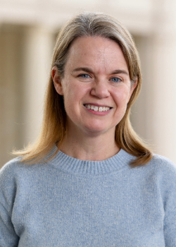 Jennifer Locke headshot with a blue sweater (best)