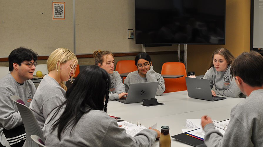 Members of Oxy's Law Society sit together reviewing a case