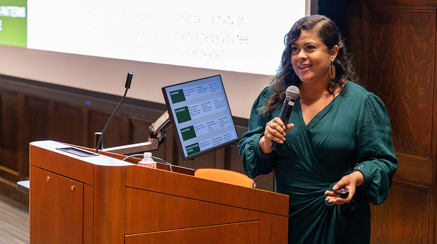 Maya Soetoro-Ng standing and lecturing at a podium in Choi Auditorium